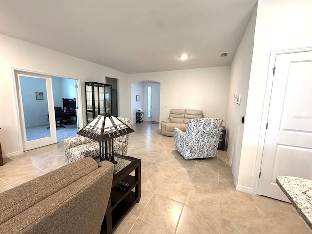 living room featuring french doors and light tile patterned flooring