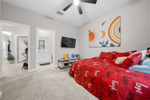 bedroom featuring ensuite bath, ceiling fan, and carpet