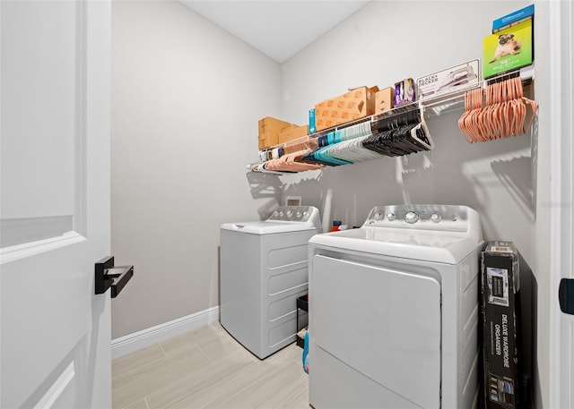 washroom with light hardwood / wood-style floors and independent washer and dryer