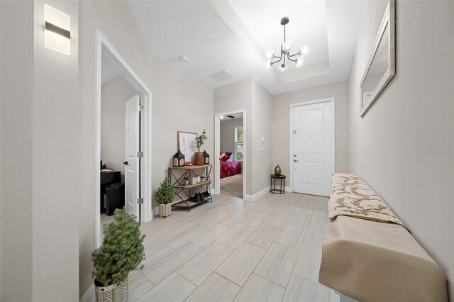 entryway with a chandelier