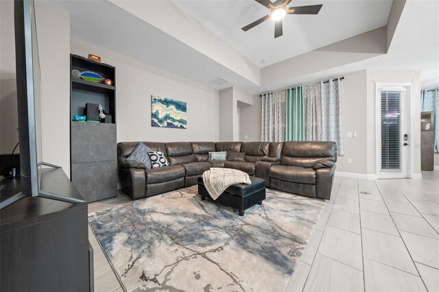 living room featuring ceiling fan and light tile patterned floors