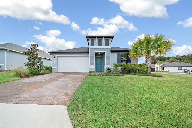 view of front of home with a garage and a front yard