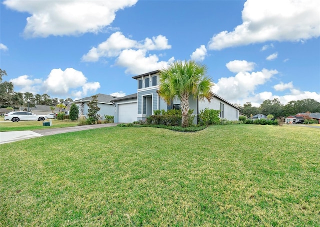 view of front of property featuring a garage and a front lawn