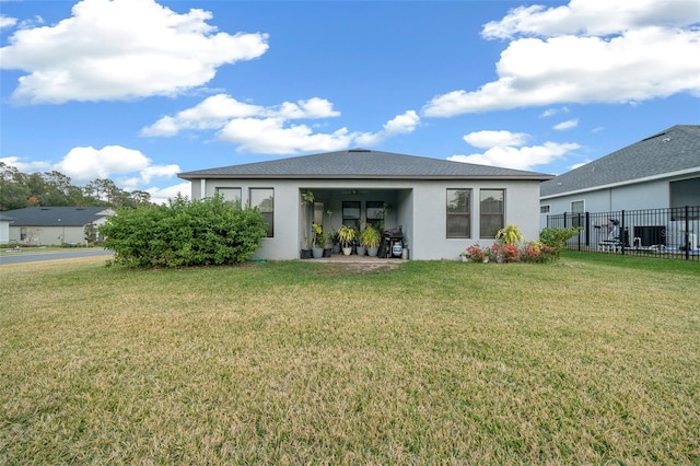 rear view of house with a lawn