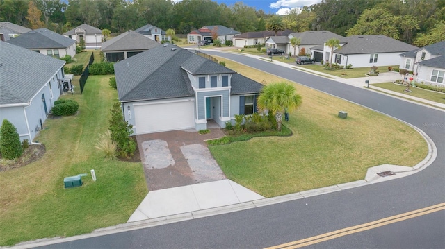 view of front facade featuring a garage and a front lawn