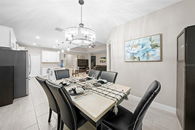 dining area featuring sink and an inviting chandelier