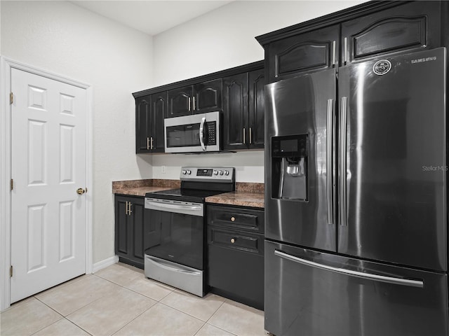 kitchen with light tile patterned floors and stainless steel appliances