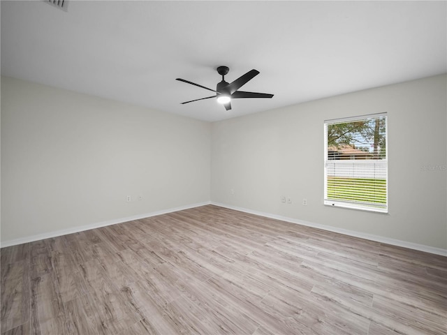 unfurnished room with ceiling fan and light wood-type flooring