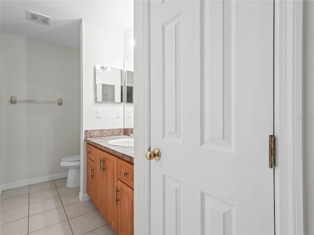 bathroom with tile patterned floors, vanity, and toilet