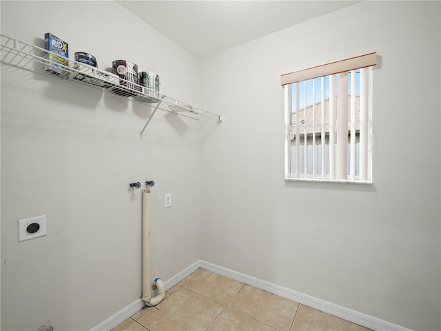 laundry area featuring hookup for an electric dryer, light tile patterned floors, and hookup for a washing machine