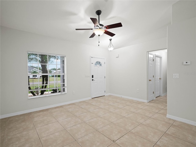 interior space featuring light tile patterned floors and ceiling fan