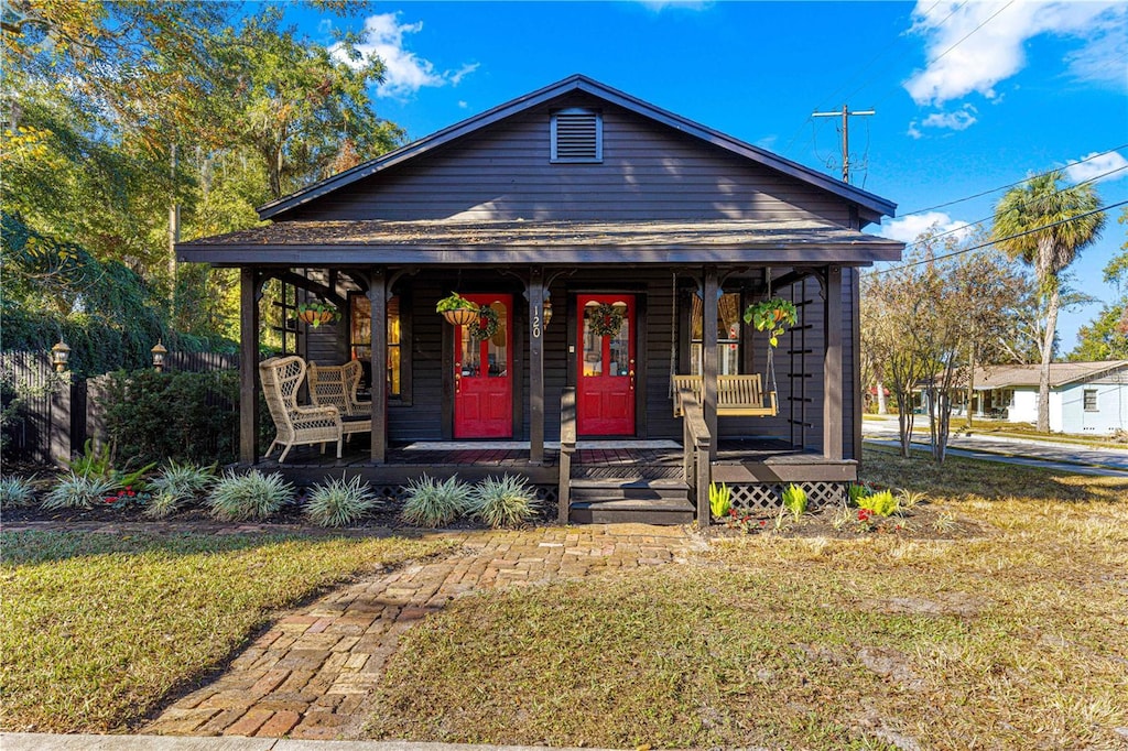 bungalow with a front yard and a porch