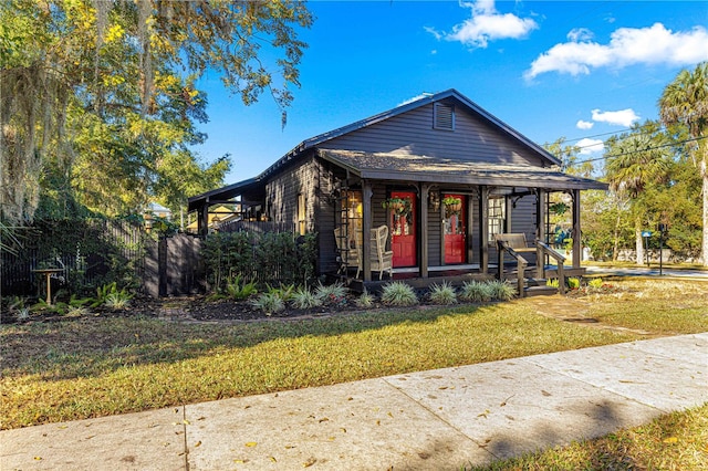 view of front of property with a front yard and a porch