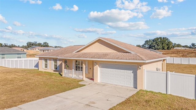 ranch-style home featuring covered porch, a garage, and a front yard