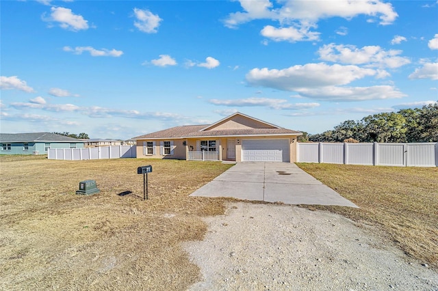 single story home featuring a front yard, a porch, and a garage