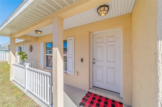 view of exterior entry featuring a porch