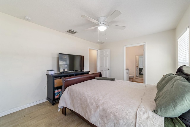 bedroom featuring ensuite bath, ceiling fan, and light hardwood / wood-style floors