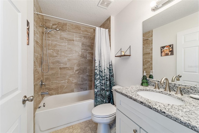 full bathroom featuring tile patterned floors, vanity, a textured ceiling, shower / tub combo with curtain, and toilet