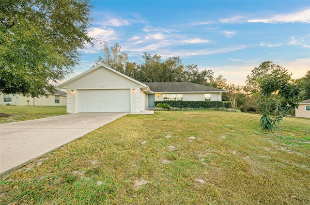 single story home with a garage and a front lawn