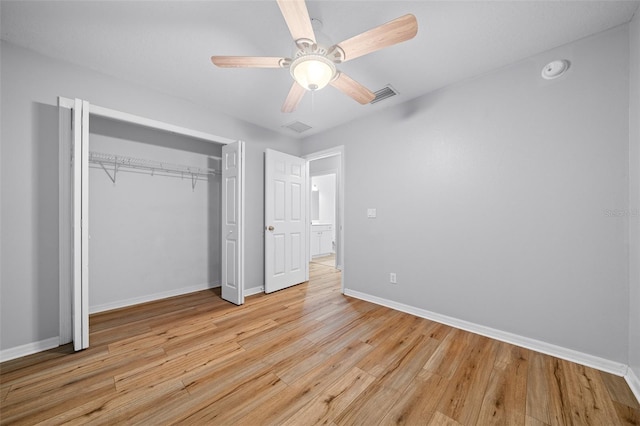 unfurnished bedroom with ceiling fan, a closet, and light wood-type flooring