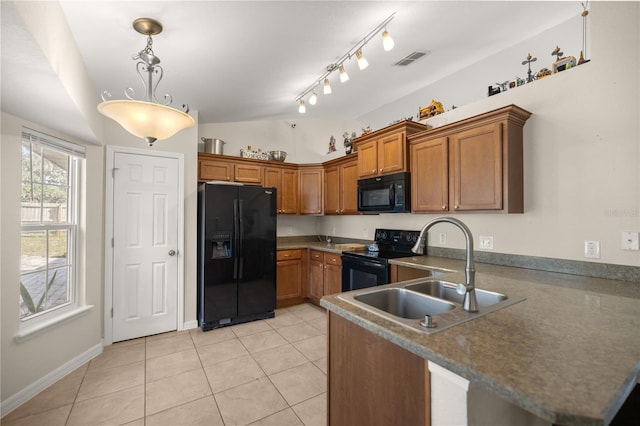 kitchen with kitchen peninsula, sink, black appliances, light tile patterned floors, and hanging light fixtures