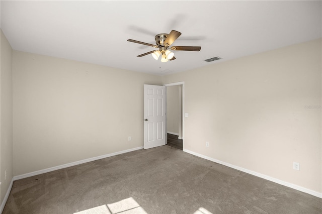 spare room with ceiling fan and carpet