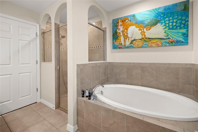 bathroom with tile patterned floors and plus walk in shower