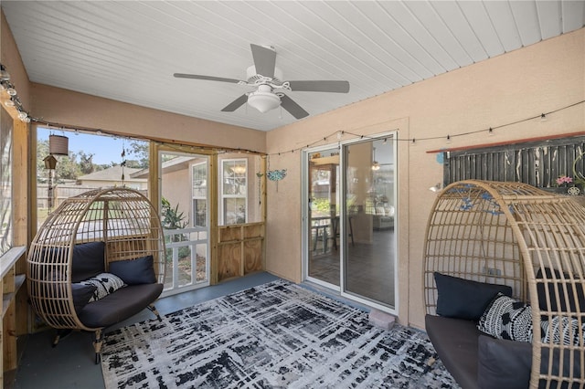 sunroom / solarium featuring ceiling fan