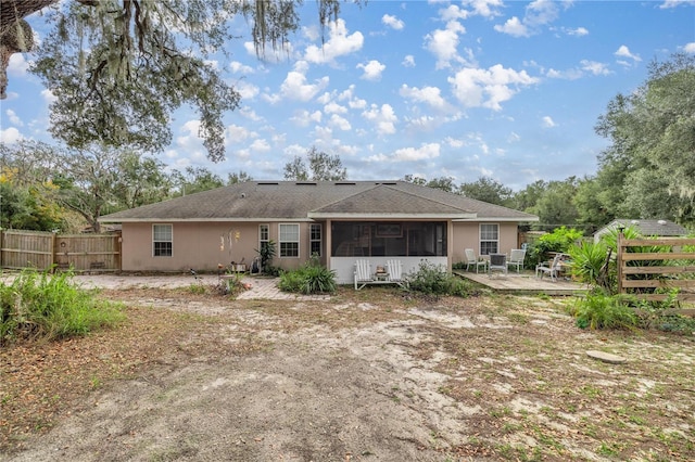 rear view of property with a deck and a sunroom