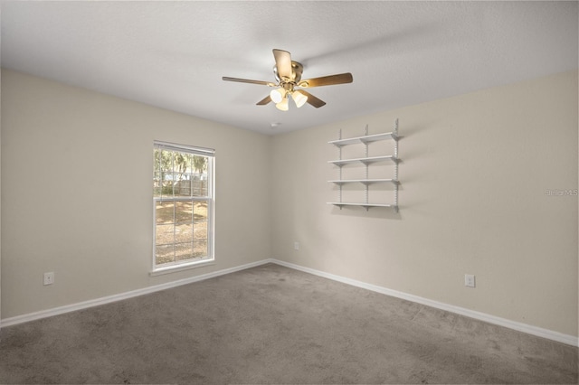 empty room featuring carpet floors and ceiling fan