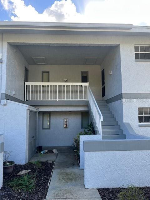 view of exterior entry featuring a balcony