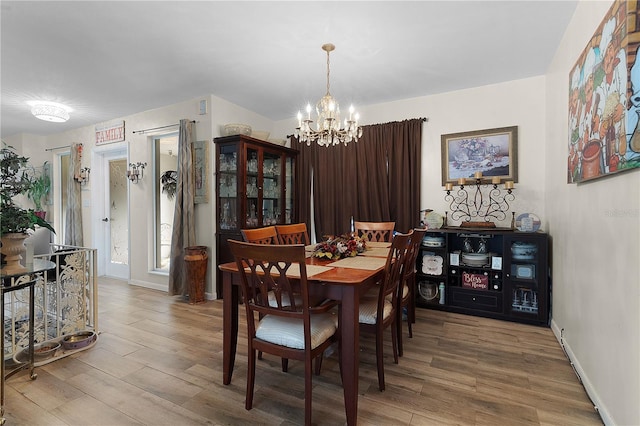 dining room featuring hardwood / wood-style flooring and a notable chandelier