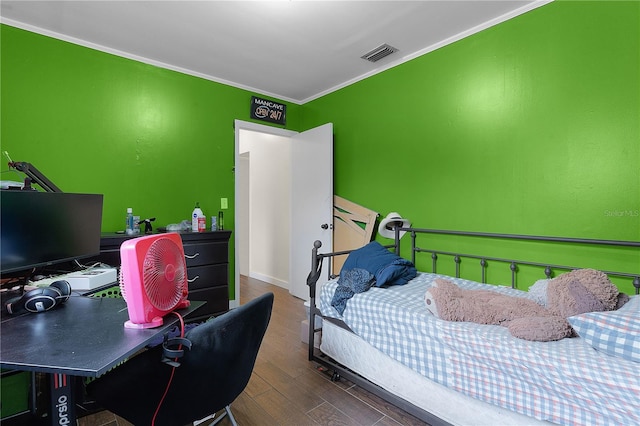 bedroom featuring dark hardwood / wood-style floors and crown molding