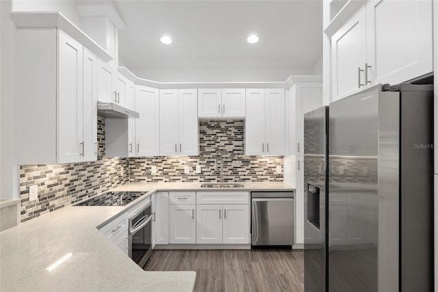 kitchen featuring appliances with stainless steel finishes, light wood-type flooring, white cabinetry, and sink