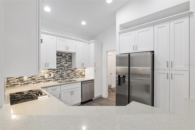 kitchen with backsplash, white cabinets, sink, dark hardwood / wood-style flooring, and stainless steel appliances