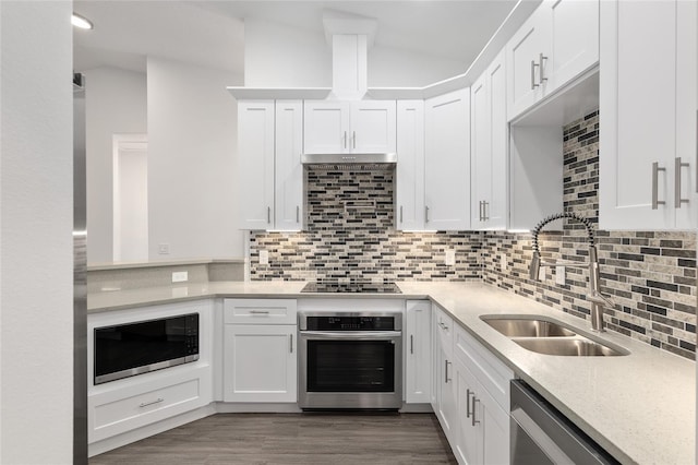 kitchen with white cabinetry, sink, lofted ceiling, and stainless steel appliances