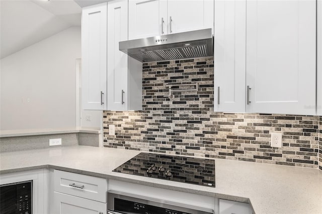 kitchen with decorative backsplash, white cabinetry, and extractor fan