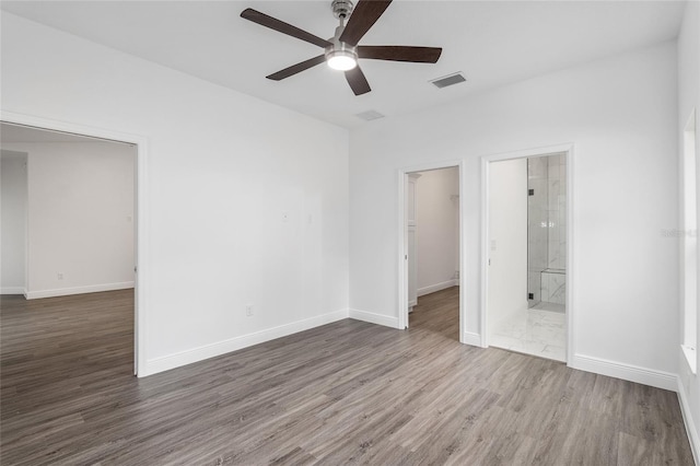 unfurnished room featuring ceiling fan and dark hardwood / wood-style flooring