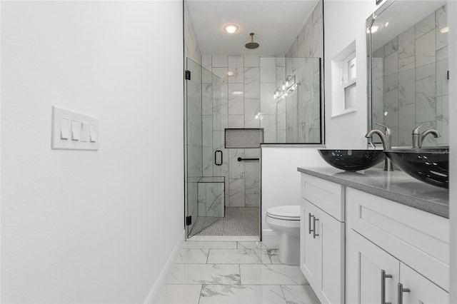 bathroom featuring vanity, toilet, and an enclosed shower