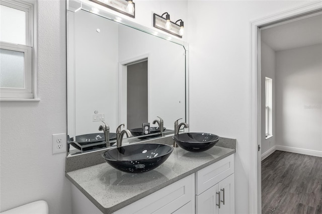 bathroom with hardwood / wood-style floors and vanity