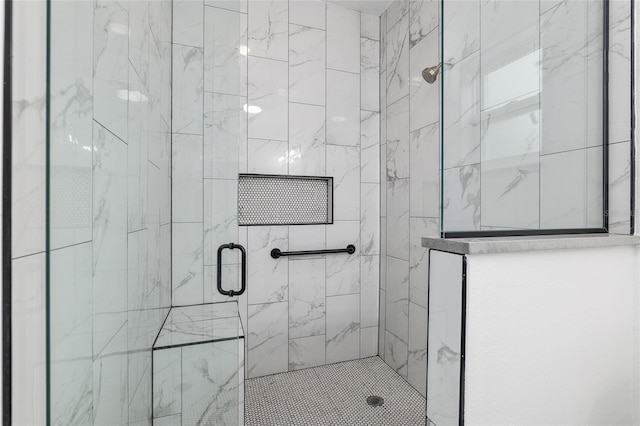 bathroom featuring a shower with door