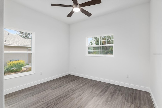 spare room featuring ceiling fan and dark hardwood / wood-style flooring