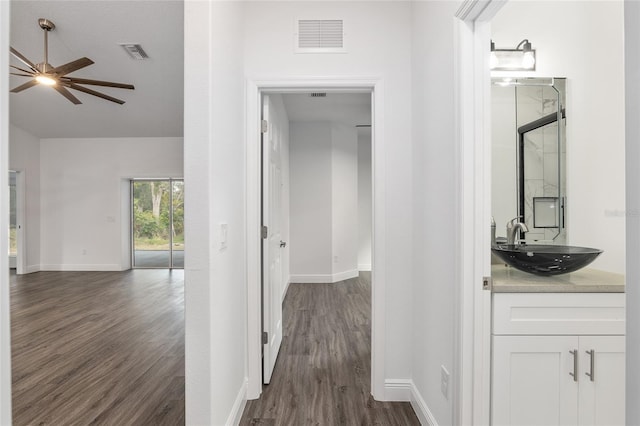 hallway featuring dark hardwood / wood-style flooring and sink