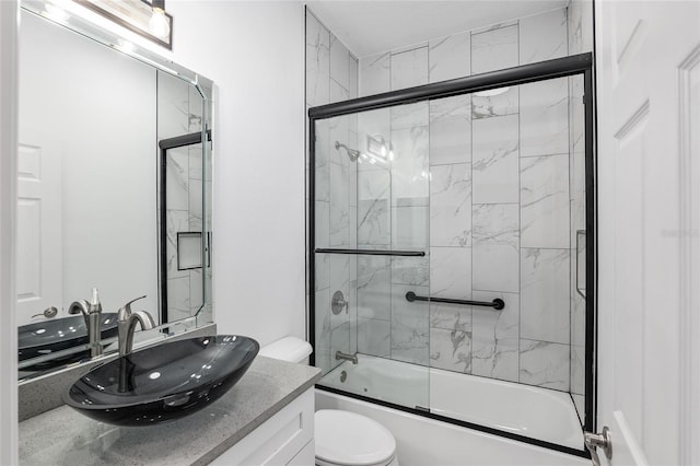 full bathroom featuring vanity, toilet, and enclosed tub / shower combo