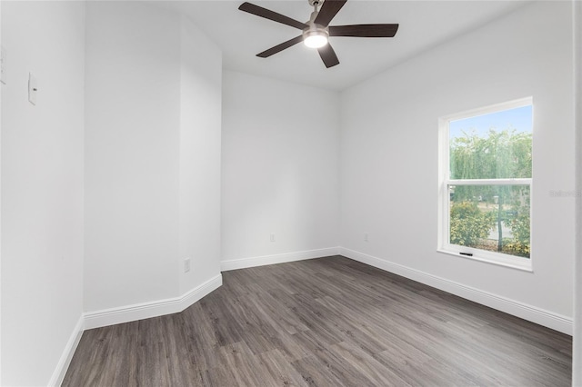 spare room with ceiling fan and dark hardwood / wood-style floors