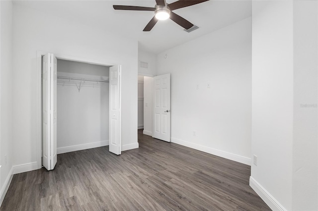 unfurnished bedroom with ceiling fan, a closet, and dark hardwood / wood-style floors