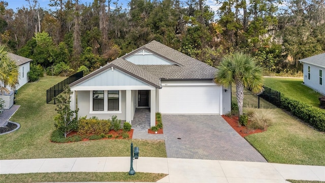 view of front of house featuring a garage and a front lawn