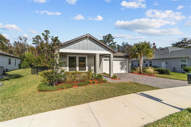 view of front facade with a front yard and a garage