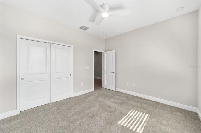 unfurnished bedroom featuring a closet, ceiling fan, and light colored carpet