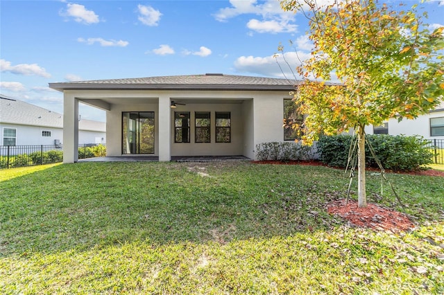 back of property with a lawn and a patio area